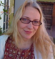 Courtney Morris Smiling woman with long blonde hair and glasses